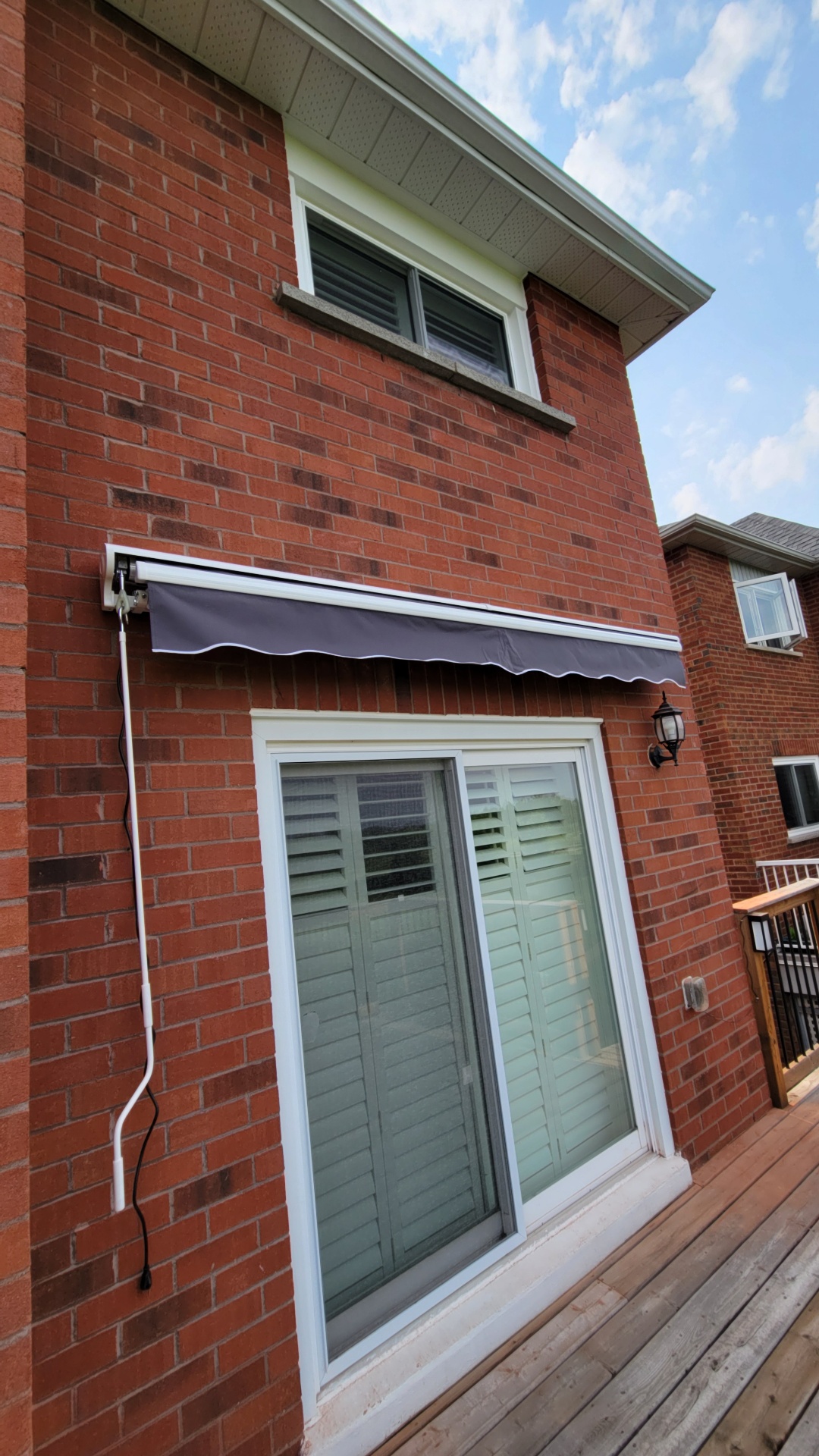 Retractable awning install on a Newmarket back deck