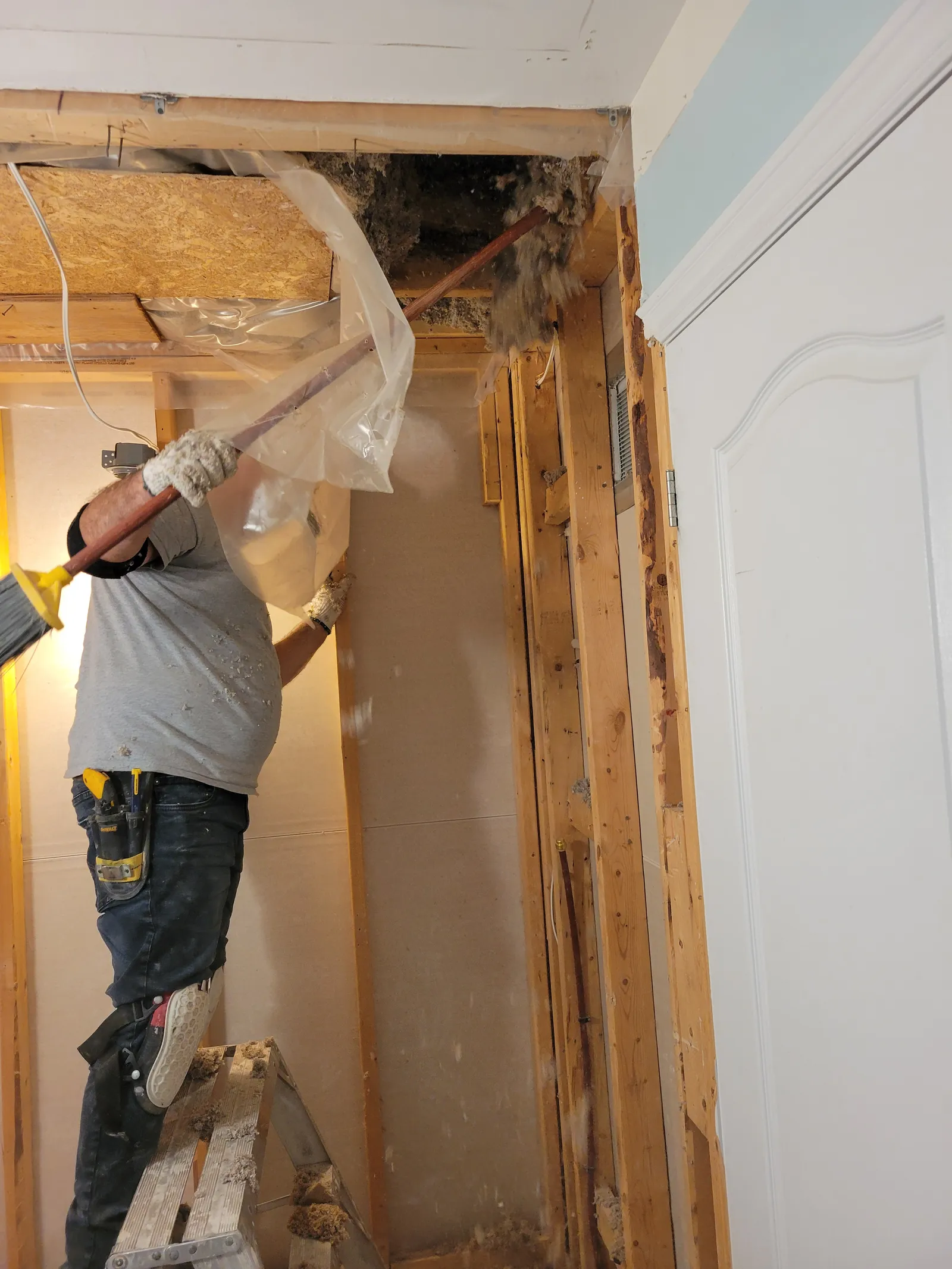 VOL Handyman tradesperson removing drywall and framing during the Aurora bathroom demolition
