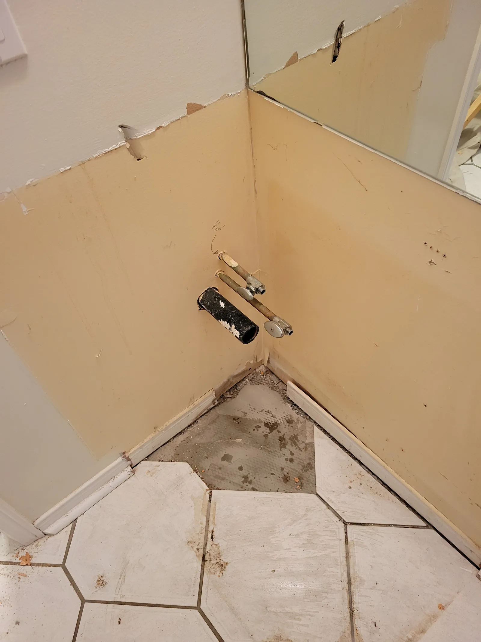 Roughed-in plumbing in the Newmarket powder room with capped copper supply stubs and a drain before the vanity goes in