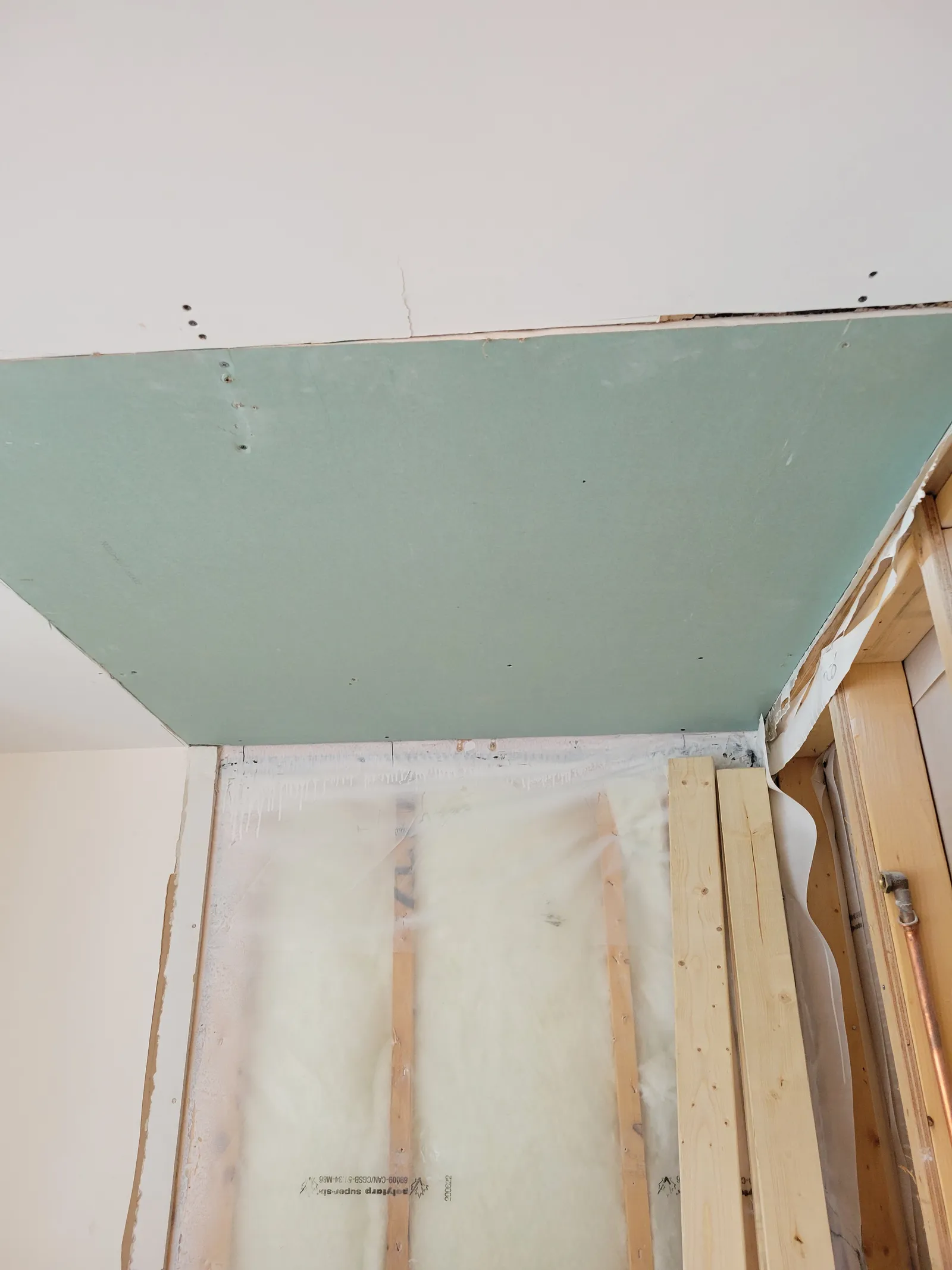 Moisture-resistant green board installed over the framed shower wall in the Vaughan bathroom