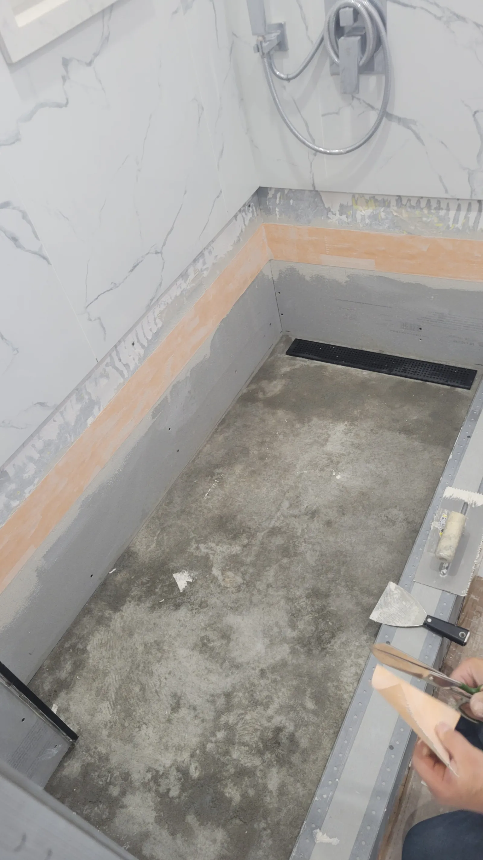 New sloped mortar bed, cement board and waterproofing band in the rebuilt Newmarket shower with a new linear drain