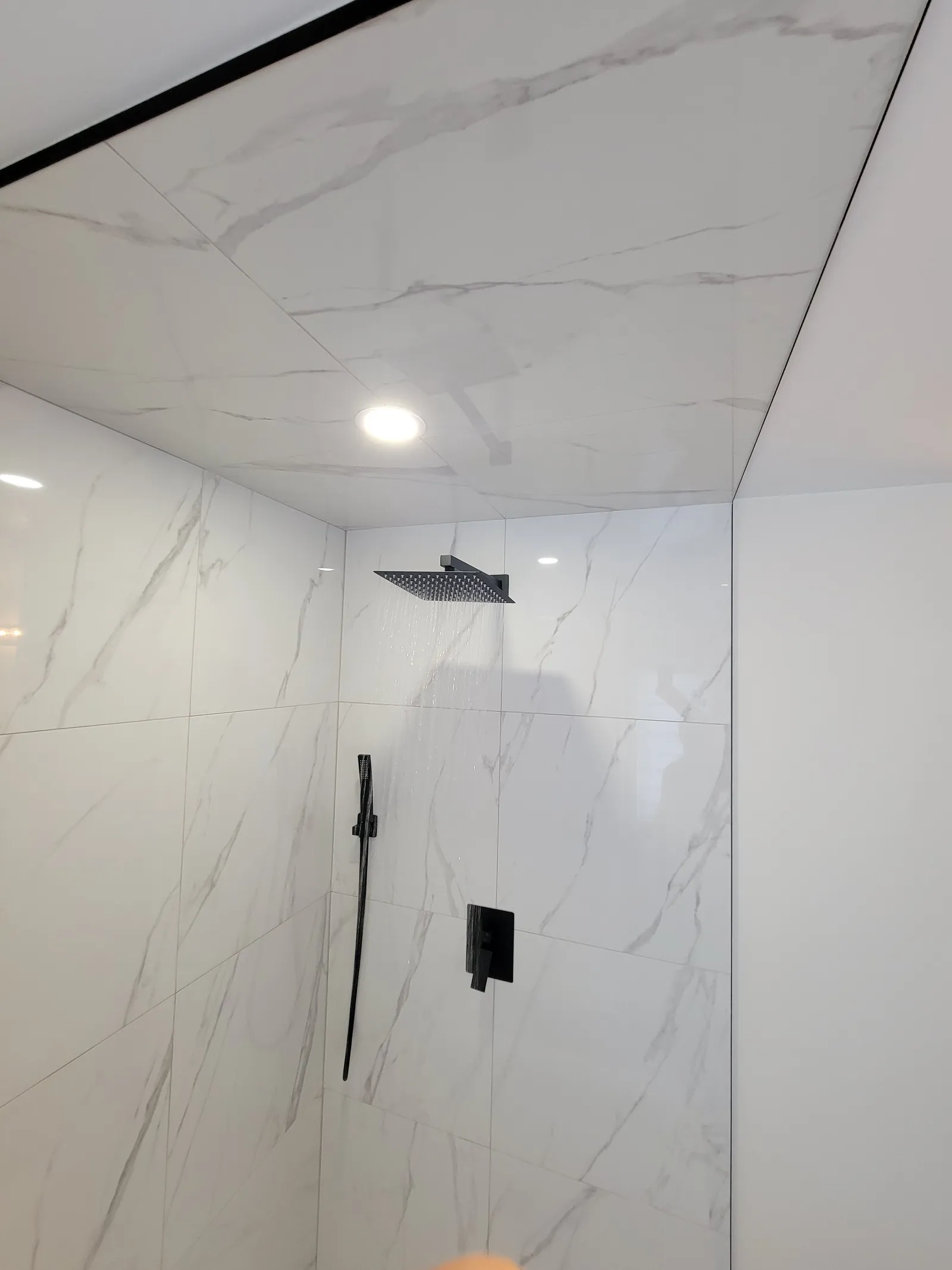 Walk-in shower, marble-look tile in Vaughan, Ontario by VOL Handyman