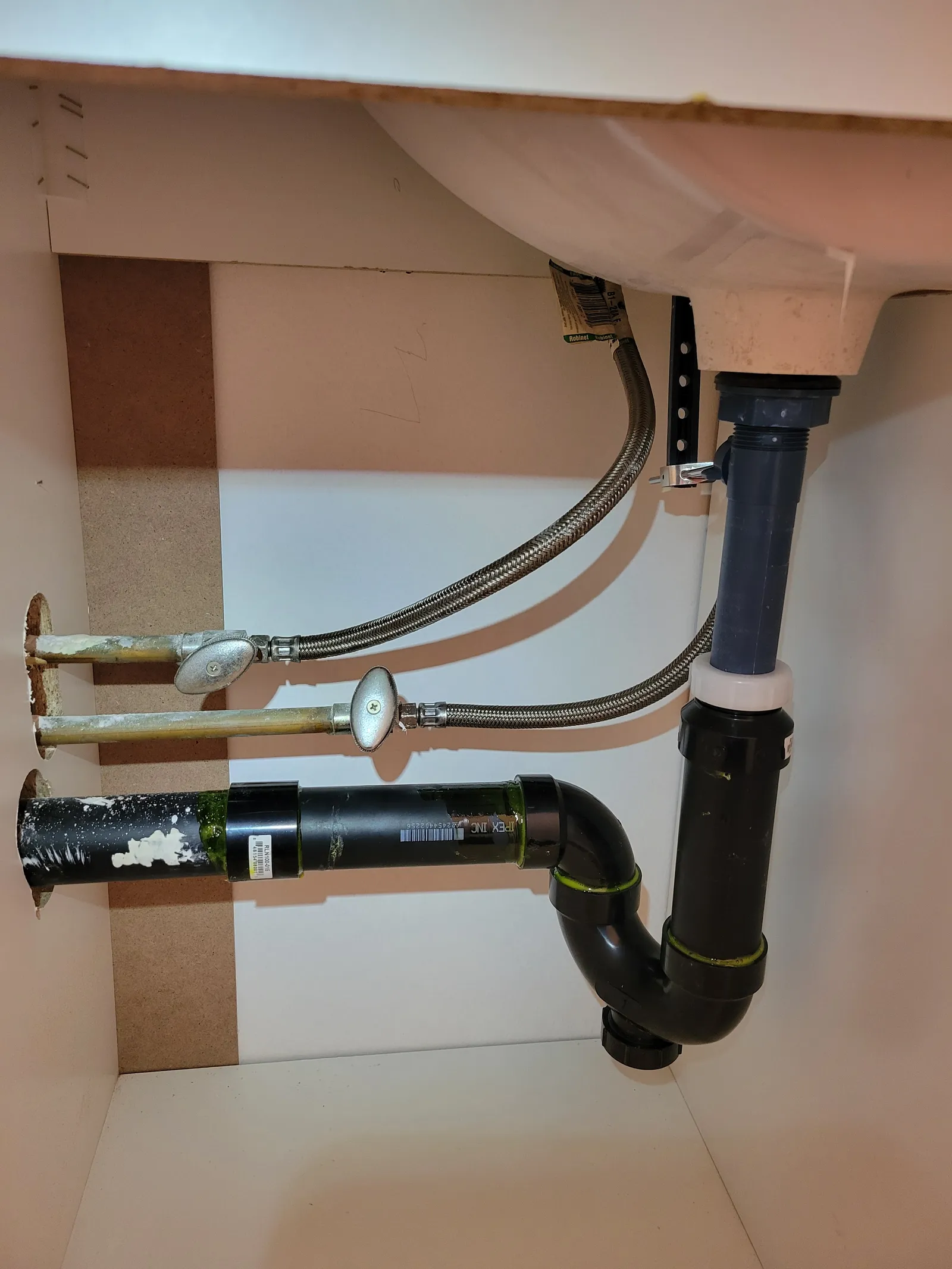 Under-sink drain, P-trap and shut-off valves being rebuilt in a Markham kitchen cabinet stripped back